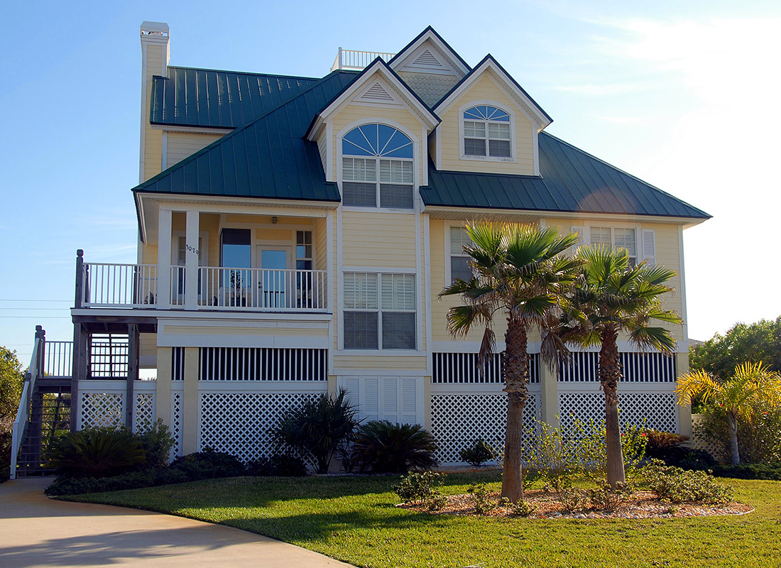 Home Insurance - Exterior View of a Florida Beach House With Palm Trees on a Sunny Day